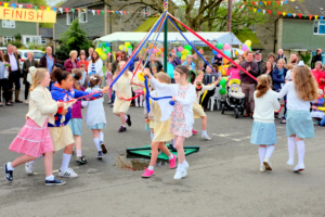 school kids wrapping may pole