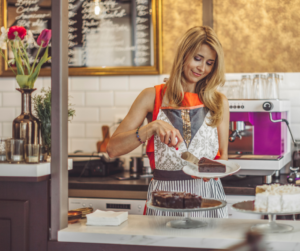 woman in bakery serving cake